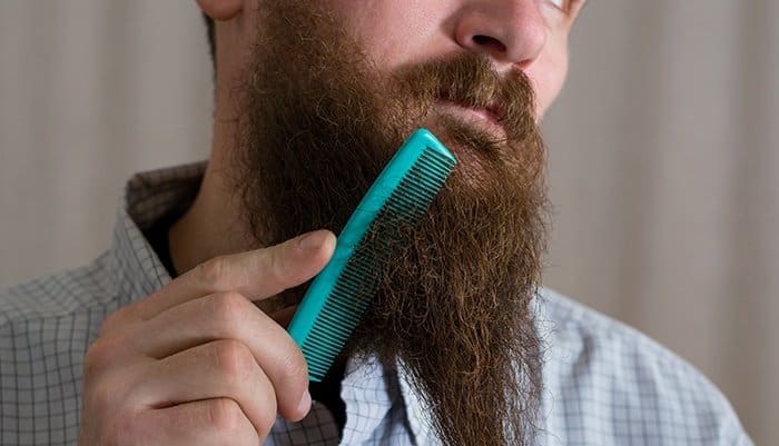 man combing his beard